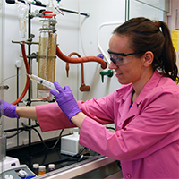 Student wearing gloves and goggles