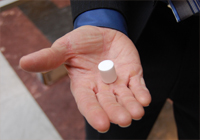 A white pellet in someone's hand.