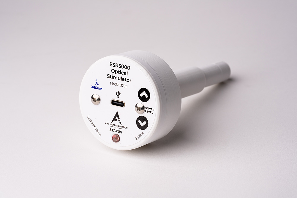 A photo of the outside of the optical stimulator. The outside has a label on the front with information and controls for the user.