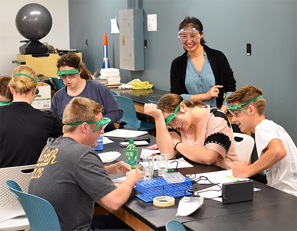 Dr. Li assists students with lab